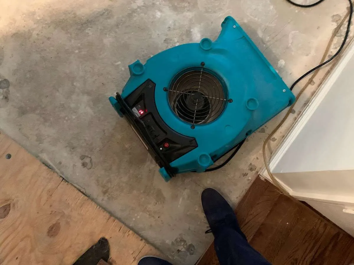 Air mover drying subfloor during Leak Detection & Repair in Mecca